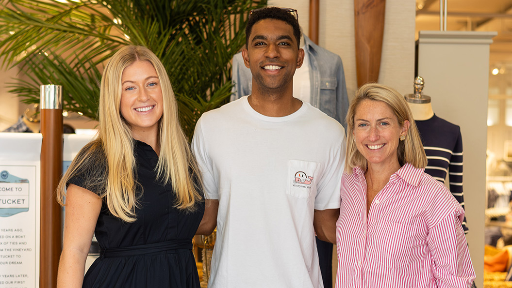 vineyard vines employee next to store table