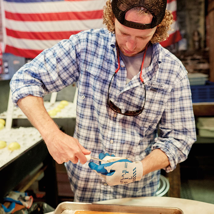 The Port Hunter employee preparing oysters