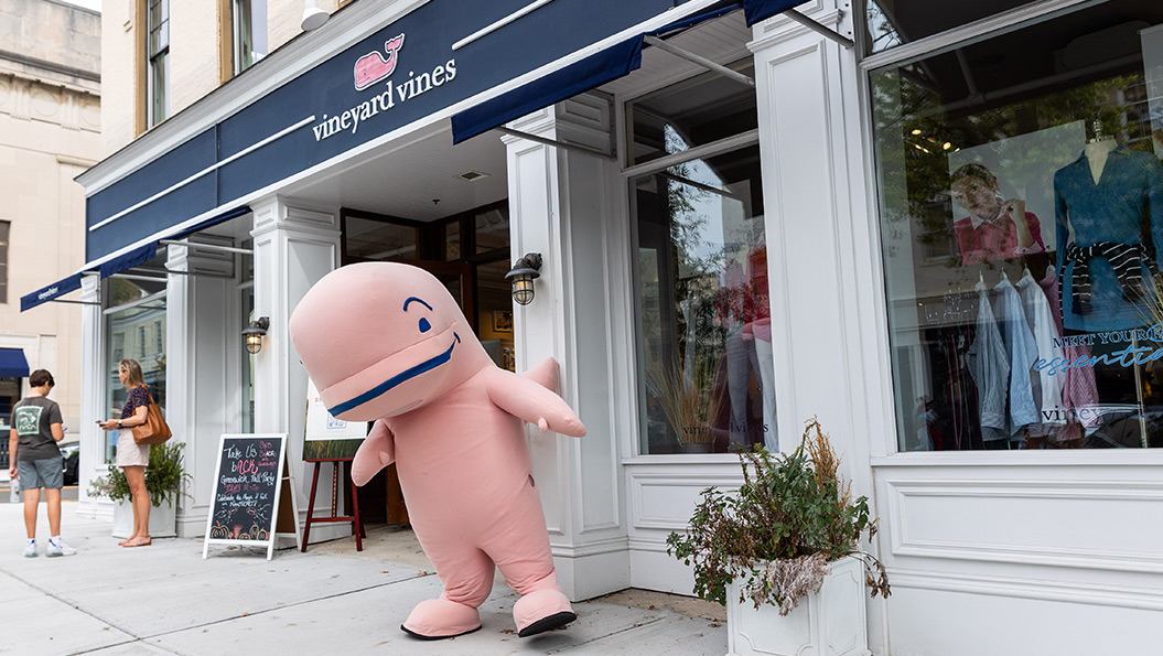 vineyard vines employee in front of store window