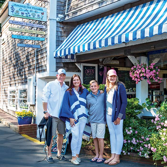 family in front of Among the Flowers Cafe