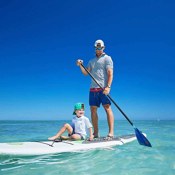 father and son paddleboarding